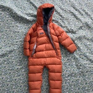 Patagonia Kids Orange with blue Puffer Onesie.